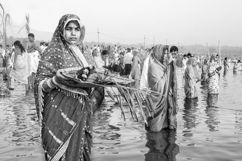 The connection between Water and Religion - Devotees offering 'arghya' on the banks of river Yamuna during Chhath Puja celebrations in North-East district, National Capital Territory of Delhi